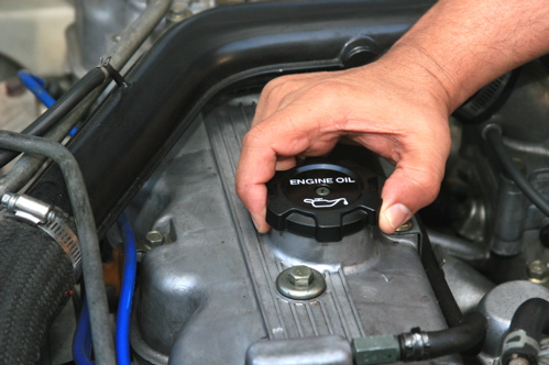 Check the oil again after a minute to let it settle down into the pan. Good? Replace and tighten oil filler cap.