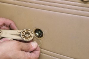 Keep an eye for hidden fasteners. This window crank has a clip to hold it in place. Attempting to pry it off without removing the clip would have damaged the panel and possibly snapped the handle.