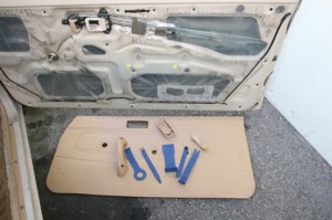 With the panel removed repairs can now be made. Be careful not to tear the plastic attached to the door. The plastic must be put back in the same place to prevent moisture damage. Shown here are all the parts removed and the tools required.